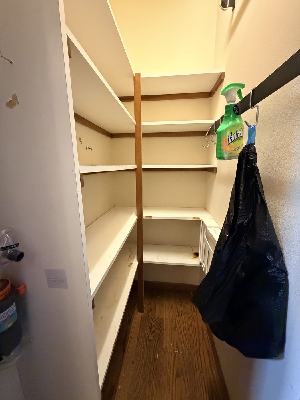 The pantry with every shelf emptied and the floor clear.